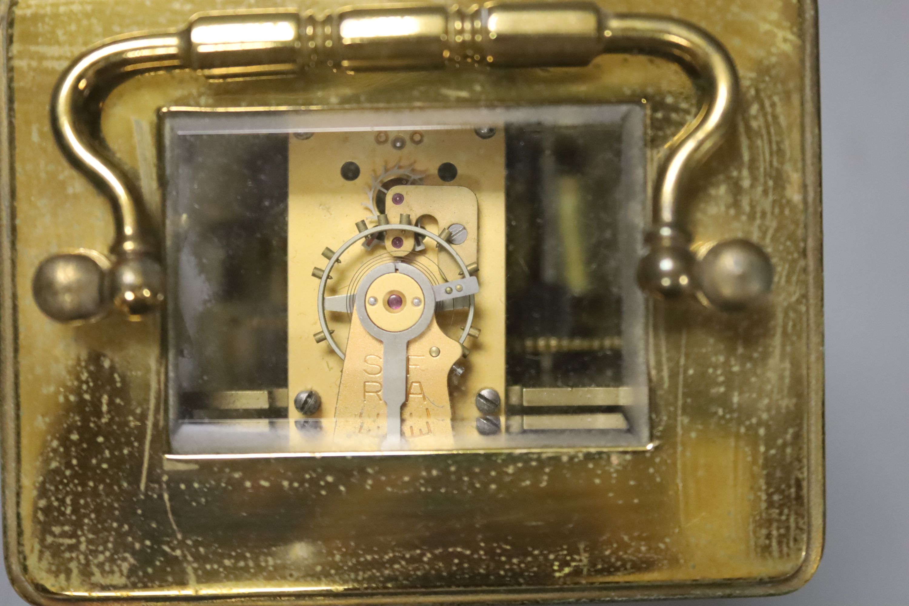 A French brass carriage alarm timepiece in leather case, 11cm high